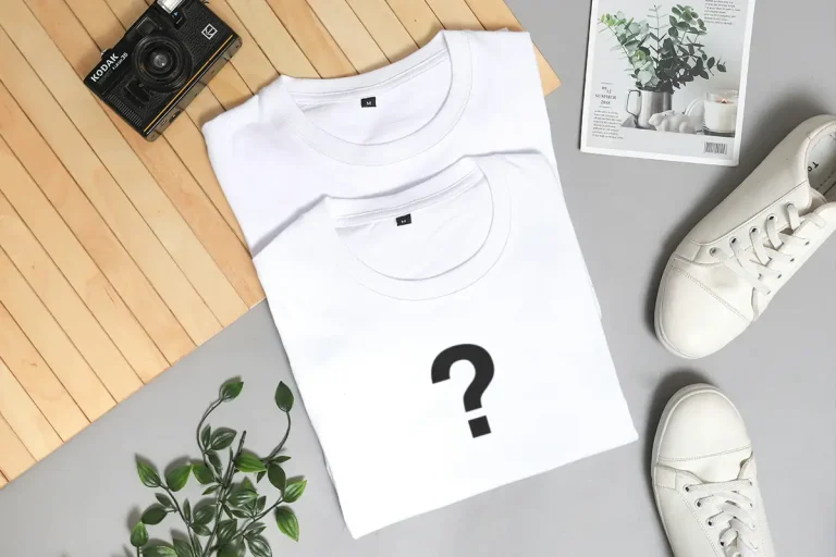 Two folded flat lay white shirts with a question mark.