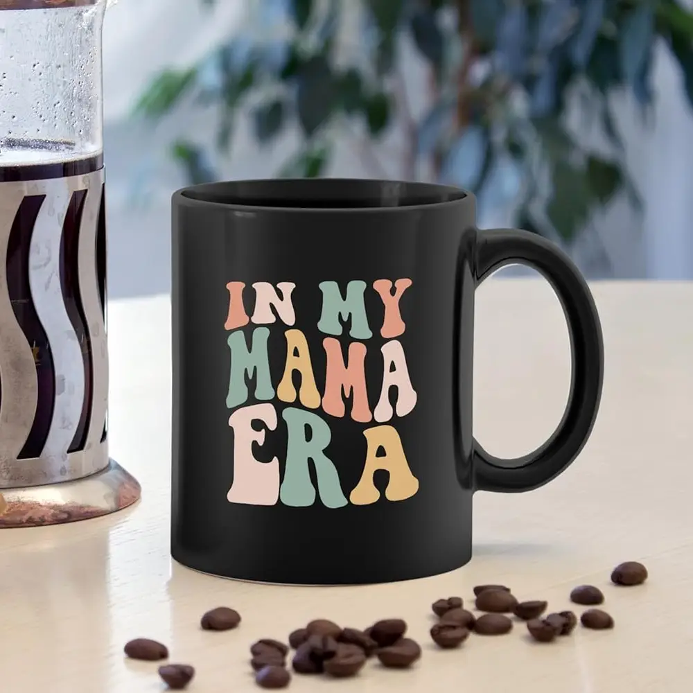 Black ceramic mug with the text "In My Mama Era"