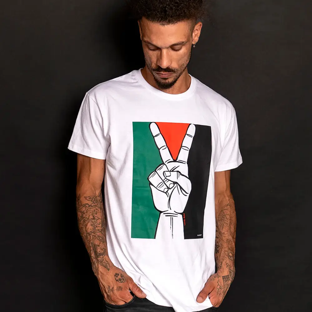 Man wearing an "activism" t-shirt featuring a peace sign and the Palestine flag